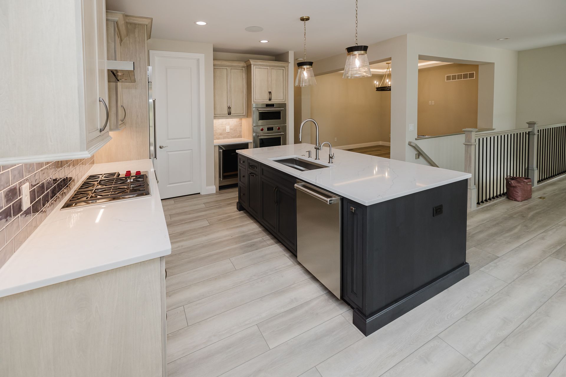 Modern kitchen of the Humphrey Bogart model with dark island, white countertops.