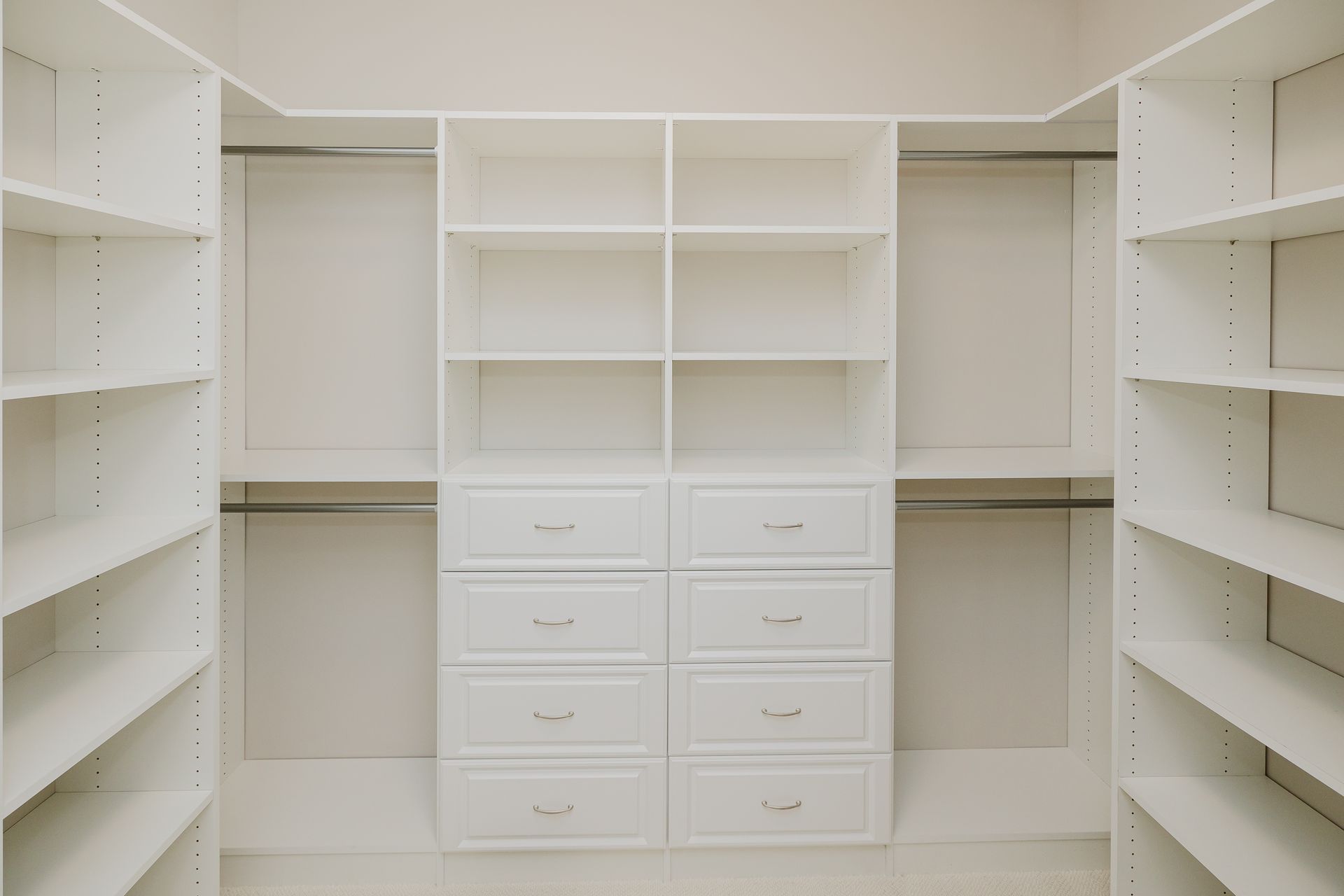 Spacious white closet in the Humphrey Bogart model with shelving, drawers, and hanging rods.