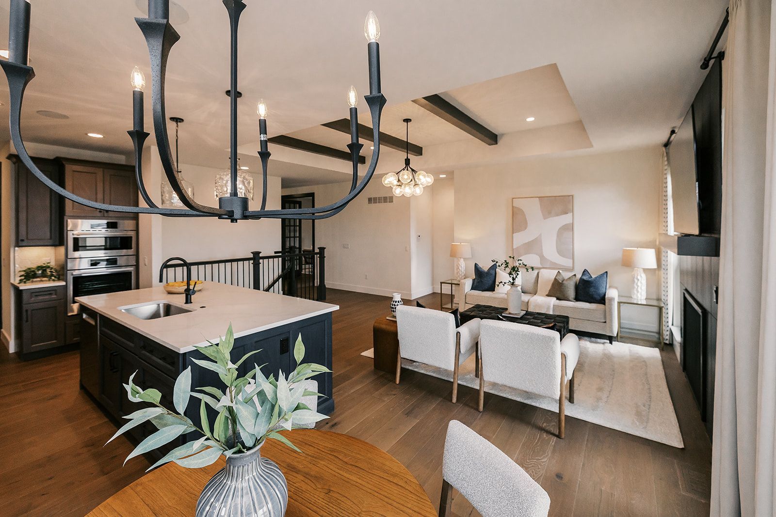 Open-concept living space in the Cary Grant model with kitchen island, dining area, and living room.