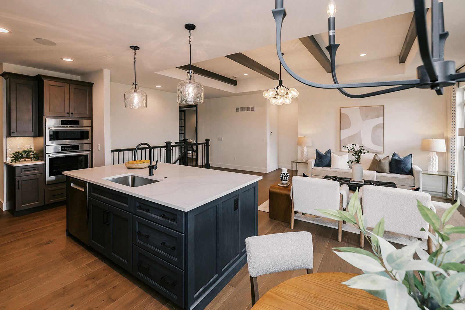 Open-concept kitchen and living room in the Cary Grant model with dark cabinetry.