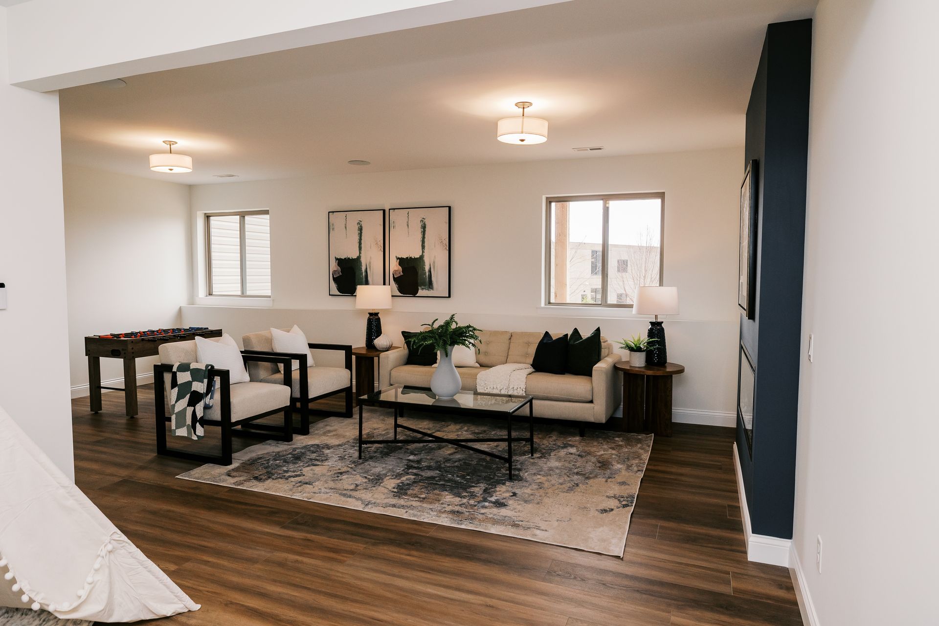 A living room in the Cary Grant model with a neutral color palette. Furniture includes a sofa, chairs, and coffee table.