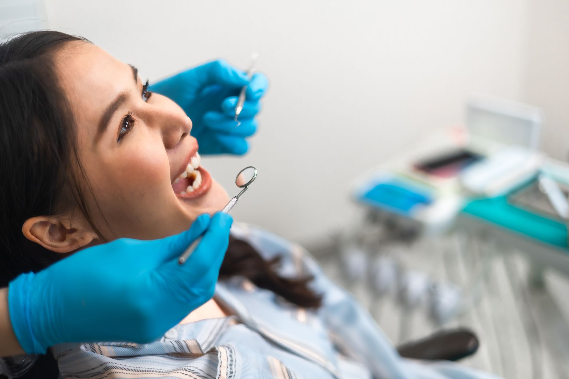A woman having her teeth examined at a dentist check-up.