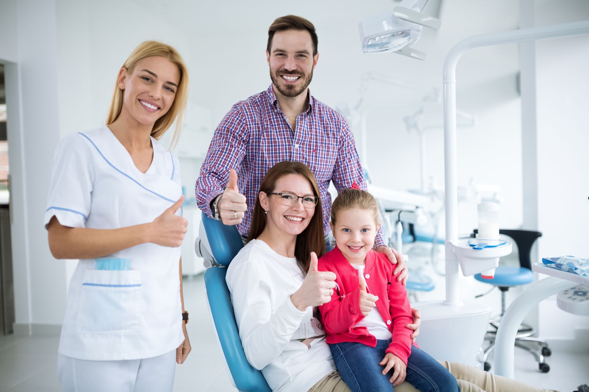 Happy family with a young dentist in a dental office.