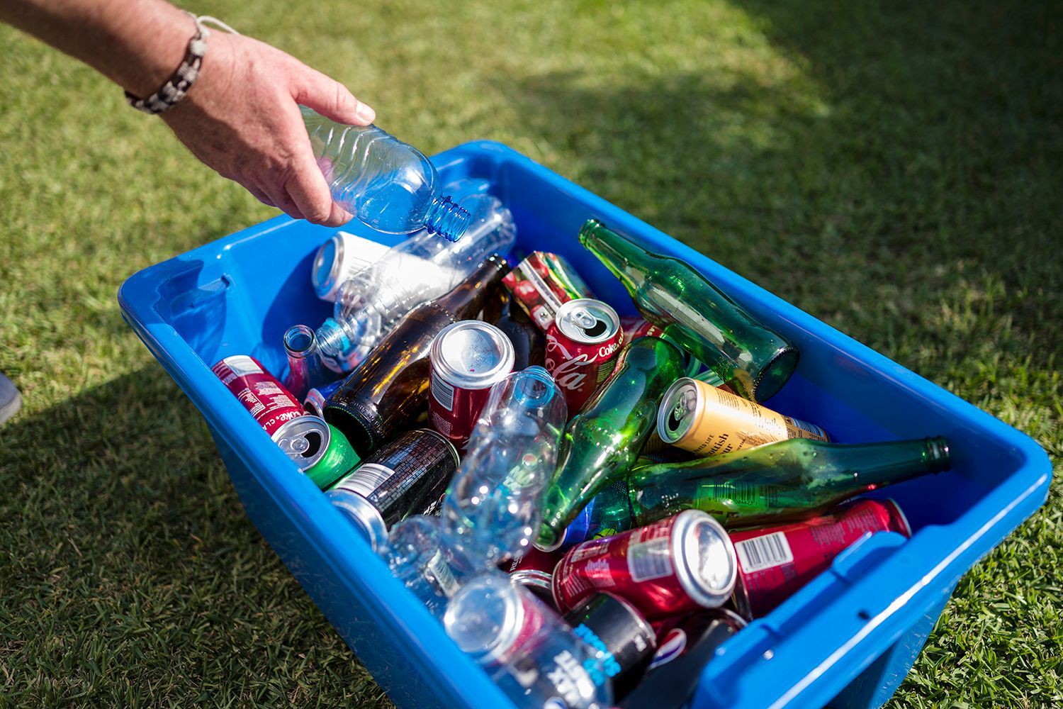 A Blue Tub Filled With Plastic Bottles And Glass Bottles — North Queensland Recycling Agents In Bungalow, QLD