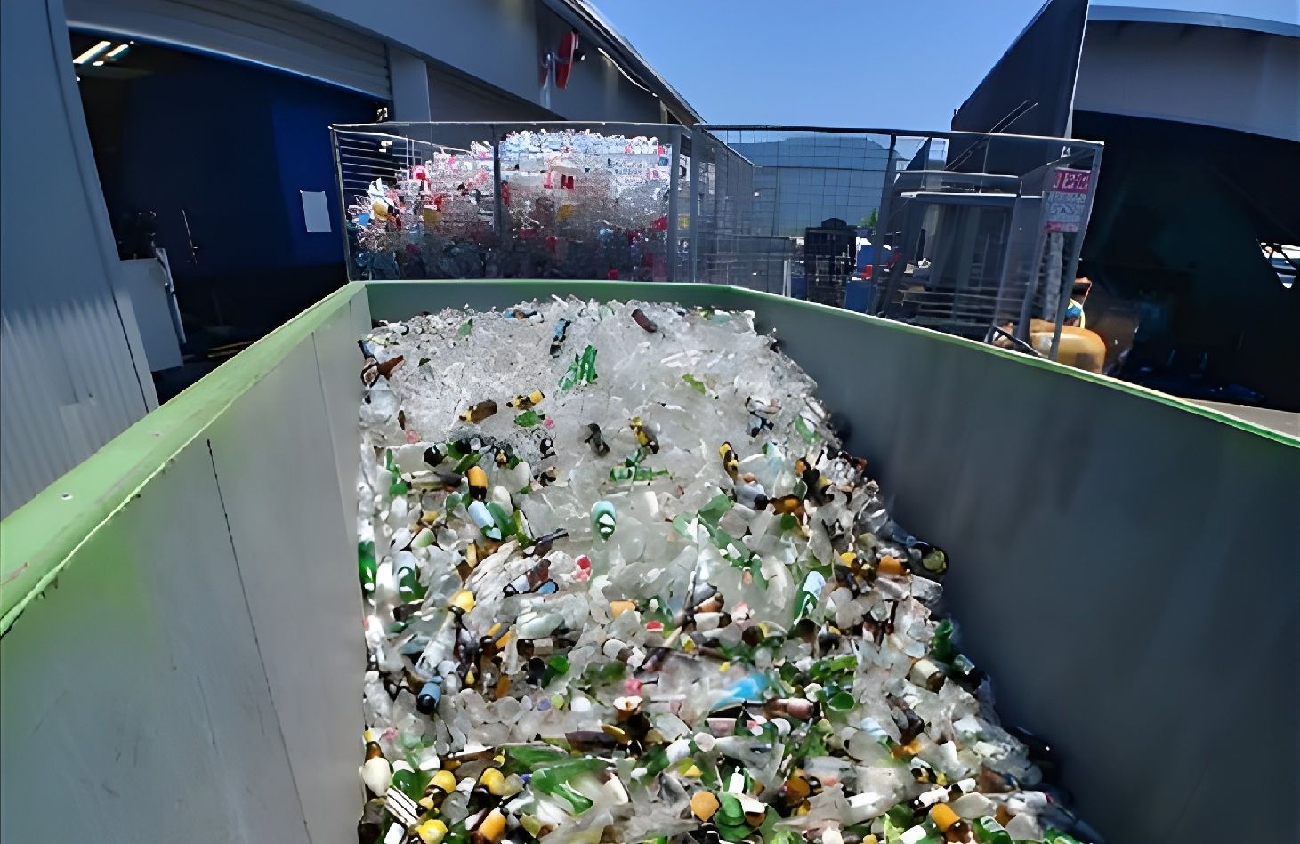 A Large Recycling Bin Filled With Collected Glass Beverage Bottles