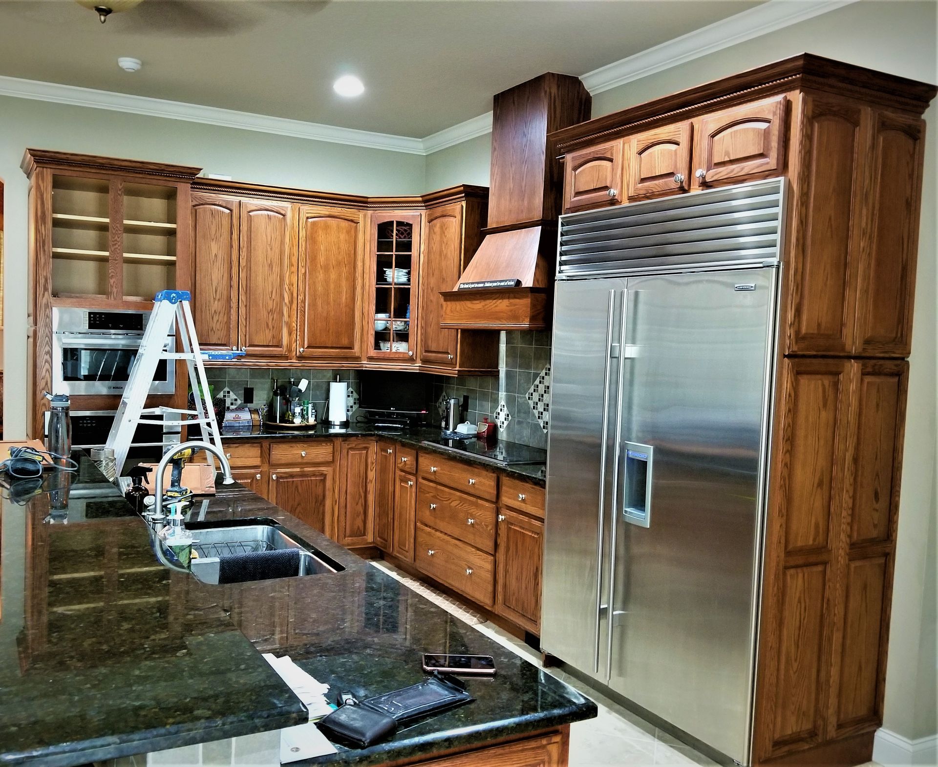 a kitchen with stainless steel appliances and wooden cabinets