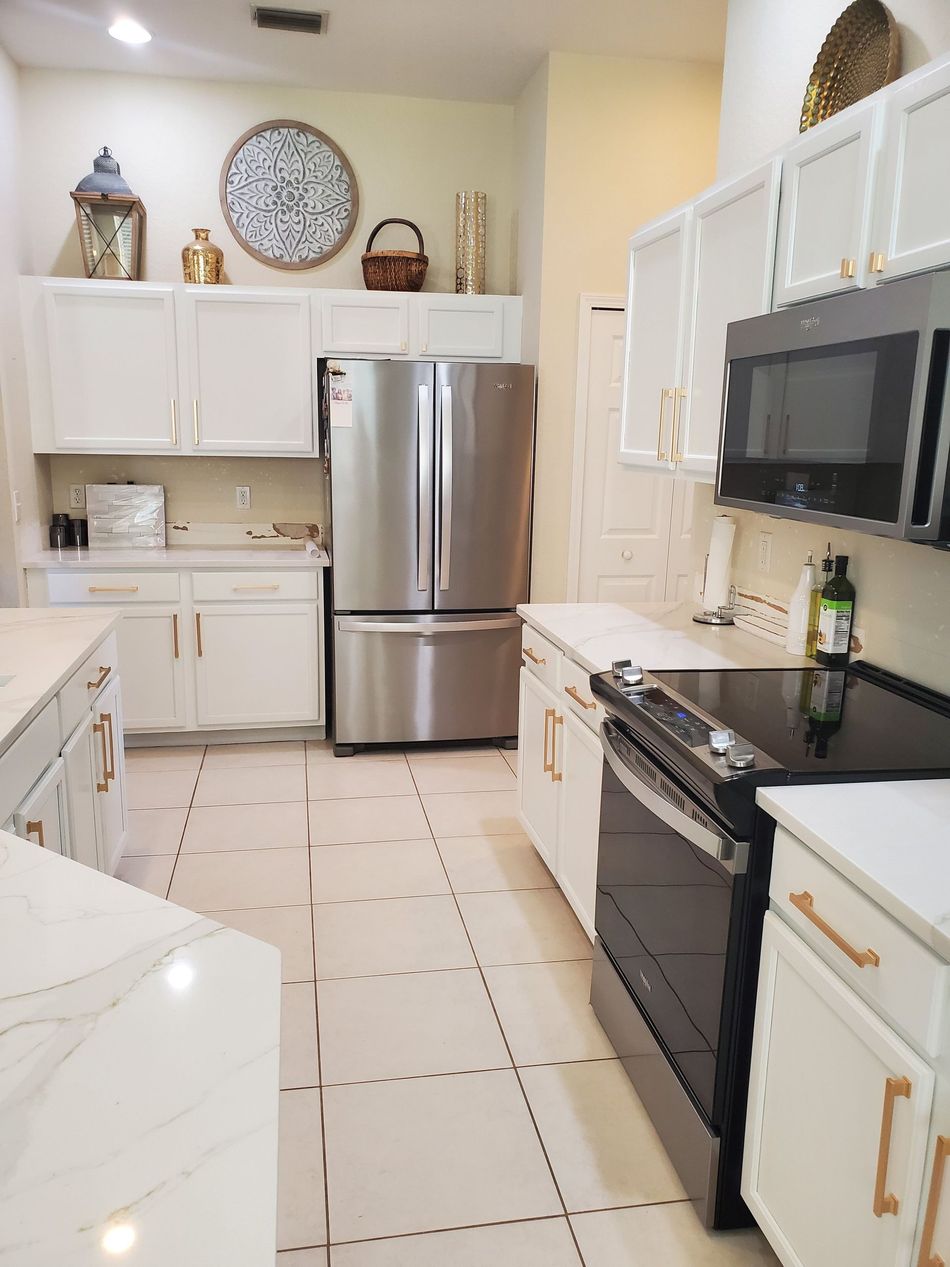 a kitchen with stainless steel appliances and white cabinets