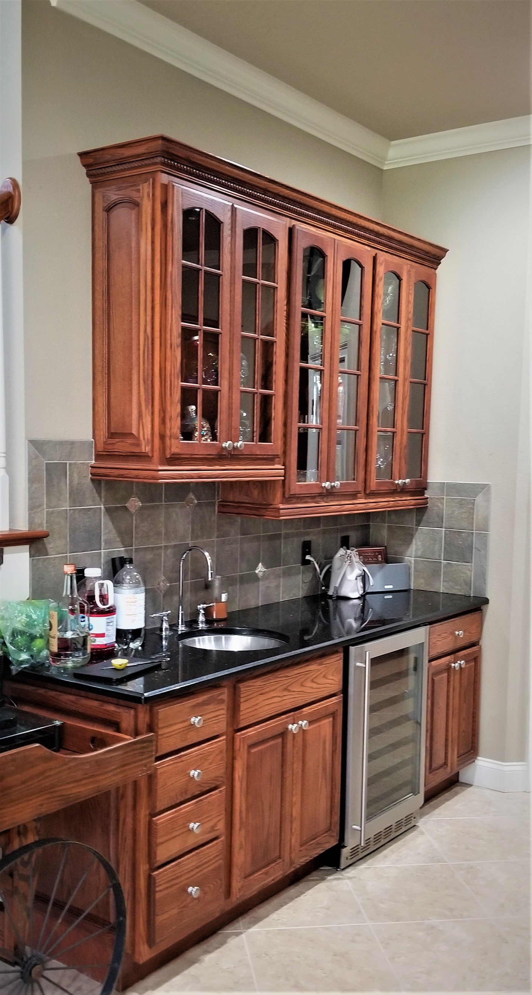 a kitchen with wooden cabinets and a stainless steel refrigerator