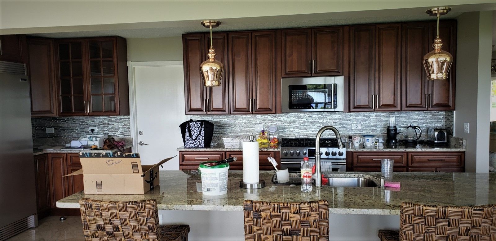 a kitchen with a cardboard box on the counter that says amazon on it