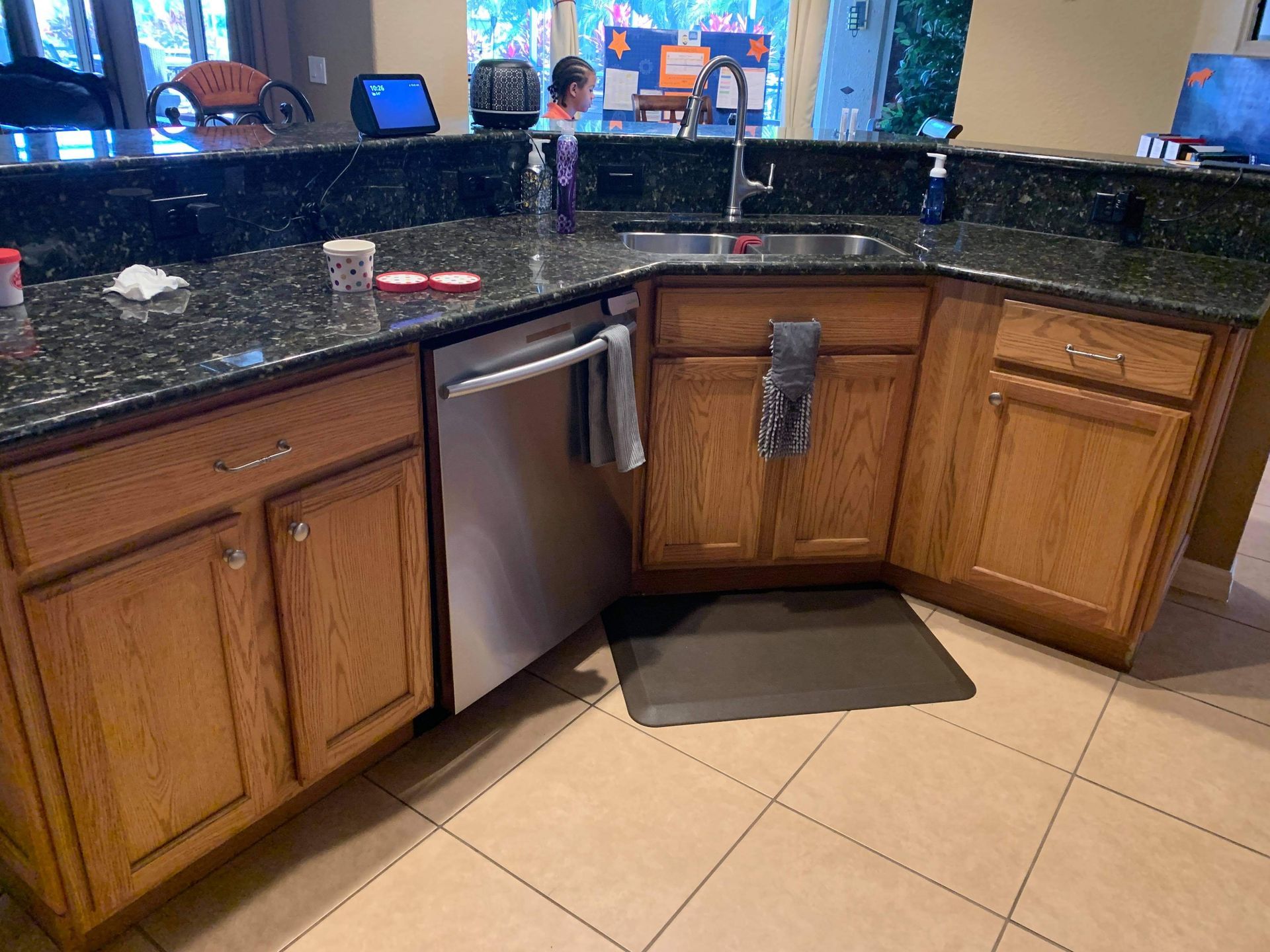 a kitchen with wooden cabinets and a stainless steel dishwasher