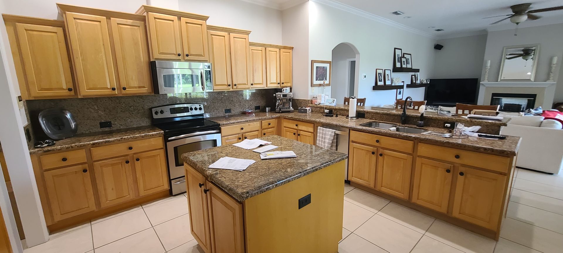 a kitchen with wooden cabinets and granite counter tops