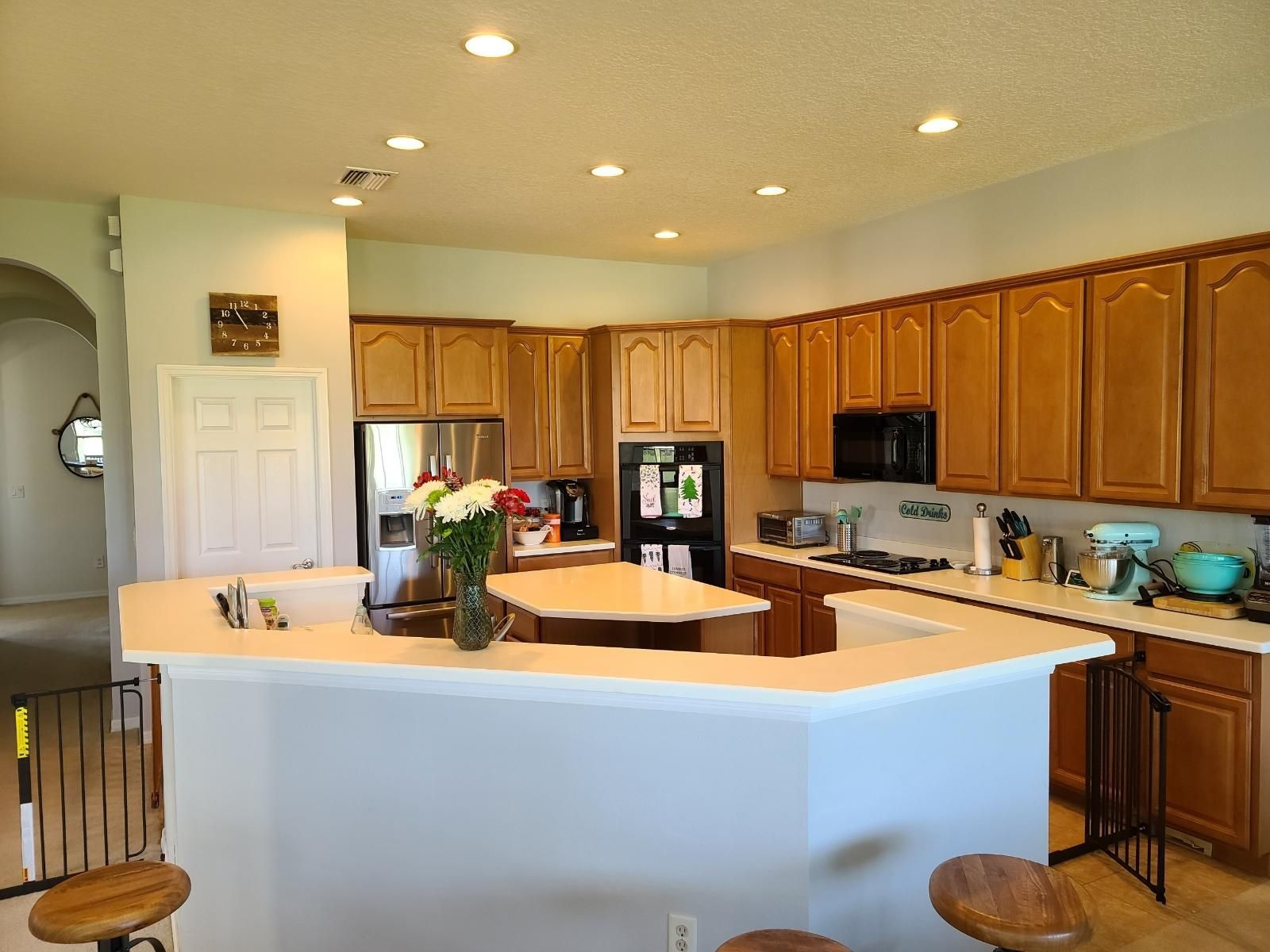 a kitchen with a sign on the refrigerator that says 