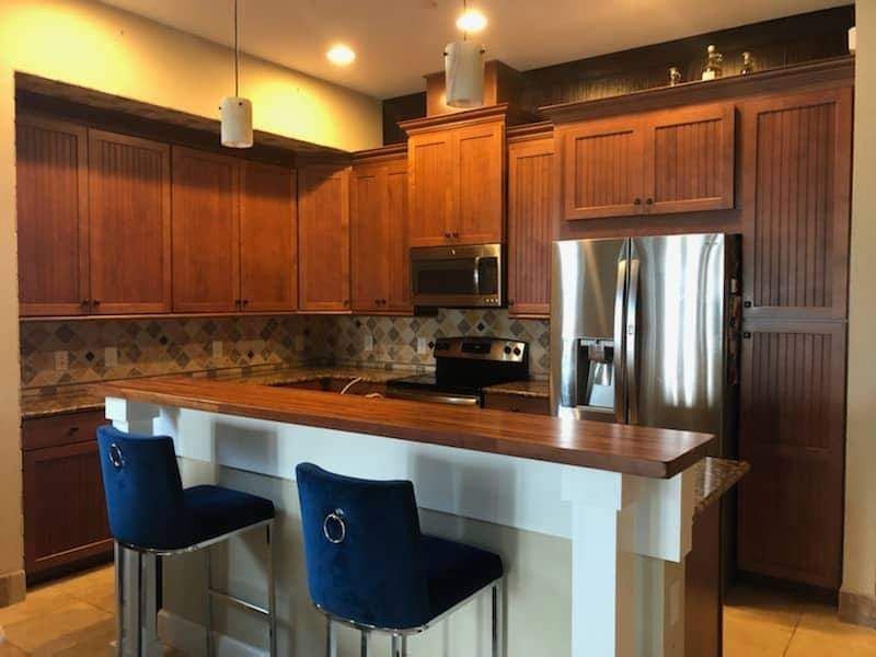a kitchen with stainless steel appliances and wooden cabinets