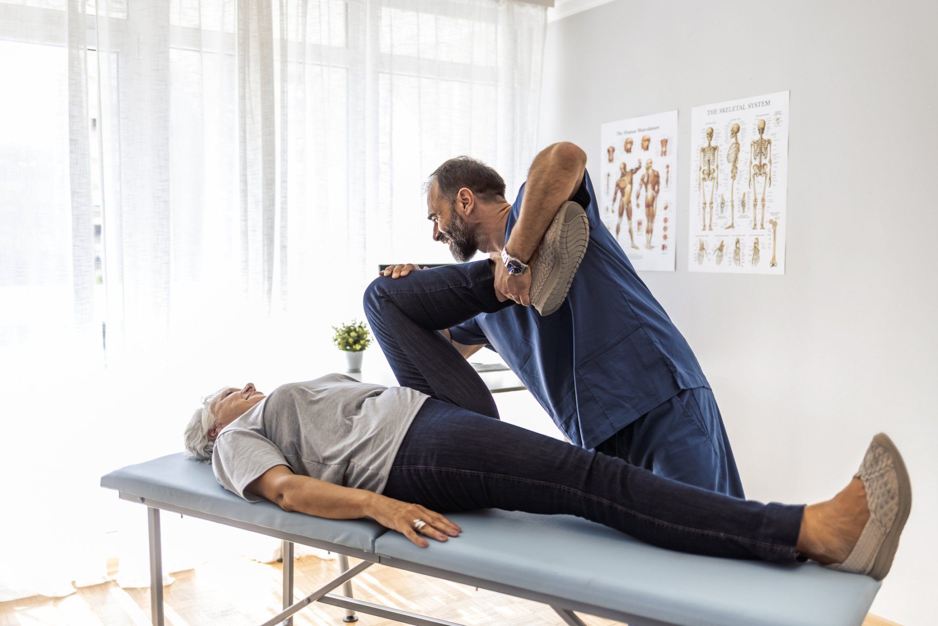 Osteopath Fixing Woman's Leg — Columbia, IL — Nobbe Chiropractic Clinic
