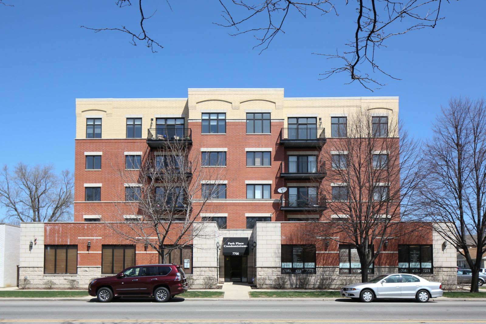 A large brick building with cars parked in front of it