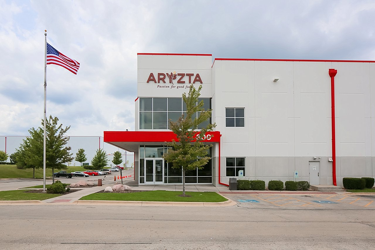 A large white building with the word aryzta on it