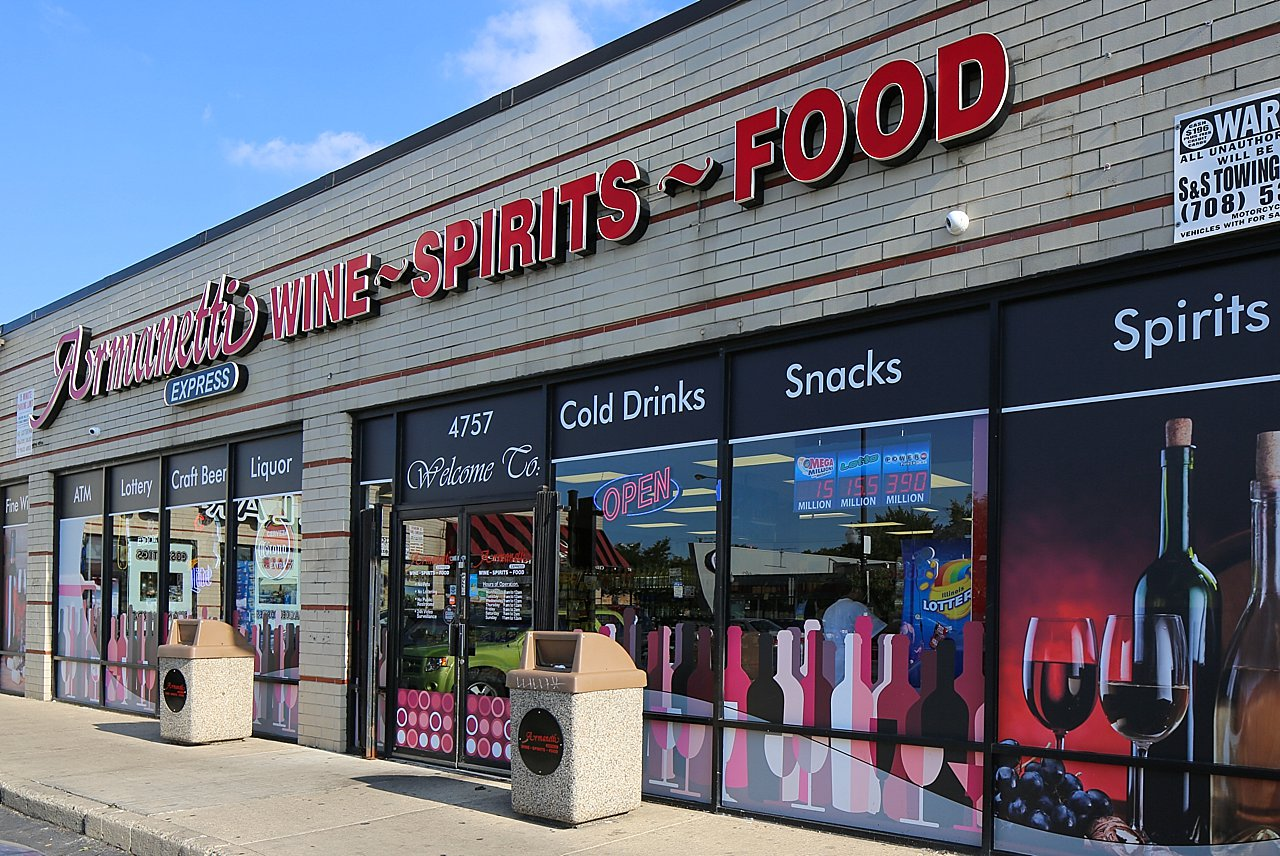 A store front with a sign that says pressed wine spirits food
