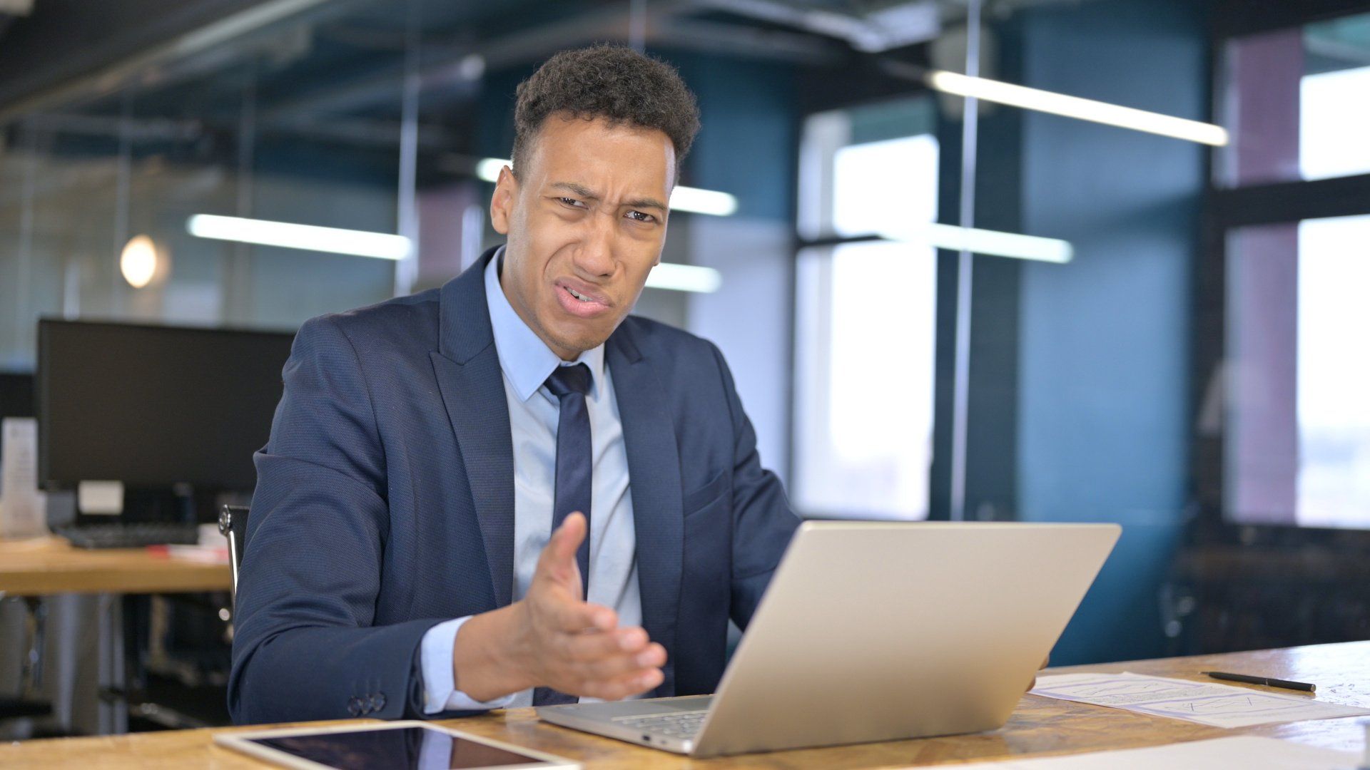 Man in business attire looking confused