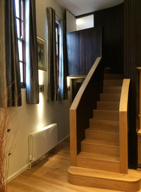 Picture of hallway and stairs painted in white with treated timber stair case by painters and decorators Derby