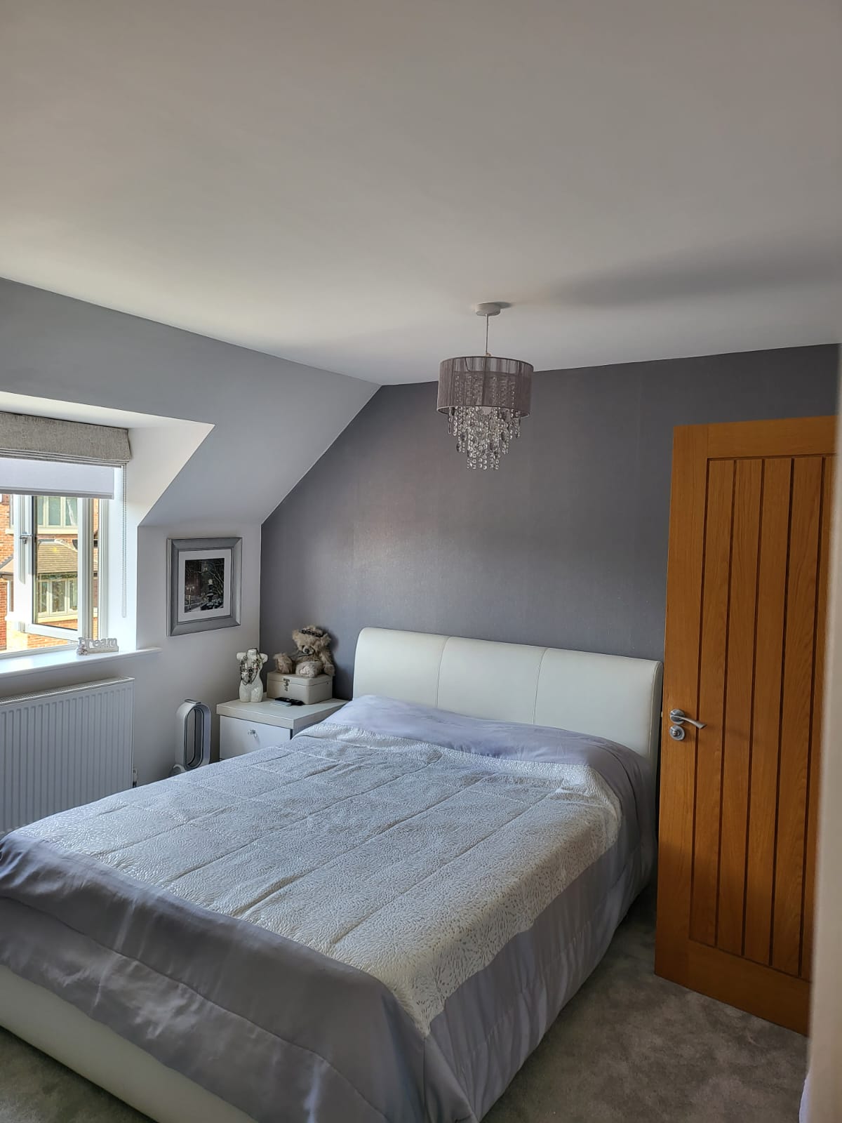 A picture of a master bedroom painted in dove grey and white by painters and decorators Derby