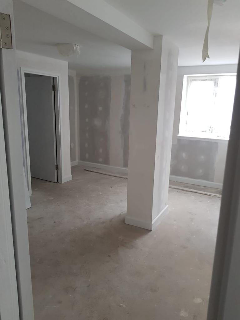 A picture of an apartment living room with new dry lining and painted white by painters and decorators Derby