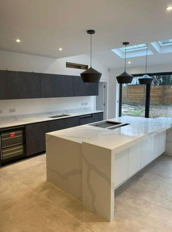 Picture of new kitchen finished with white marble worktops and white painted ceilings and walls by painters and decorators Derby