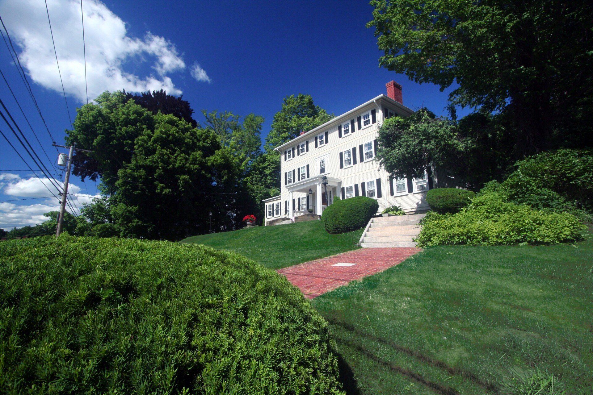 Exterior view of three story home with with chimney.