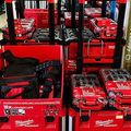 Red Milwaukee tool boxes and cordless tool kits displayed on store shelves