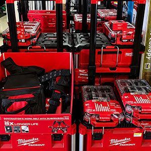 Red Milwaukee tool boxes and cordless tool kits displayed on store shelves