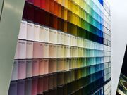 Paint swatches arranged in rows, showing a wide spectrum of colors from warm to cool tones.