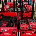 Red Milwaukee tool boxes and cordless tool kits displayed on store shelves