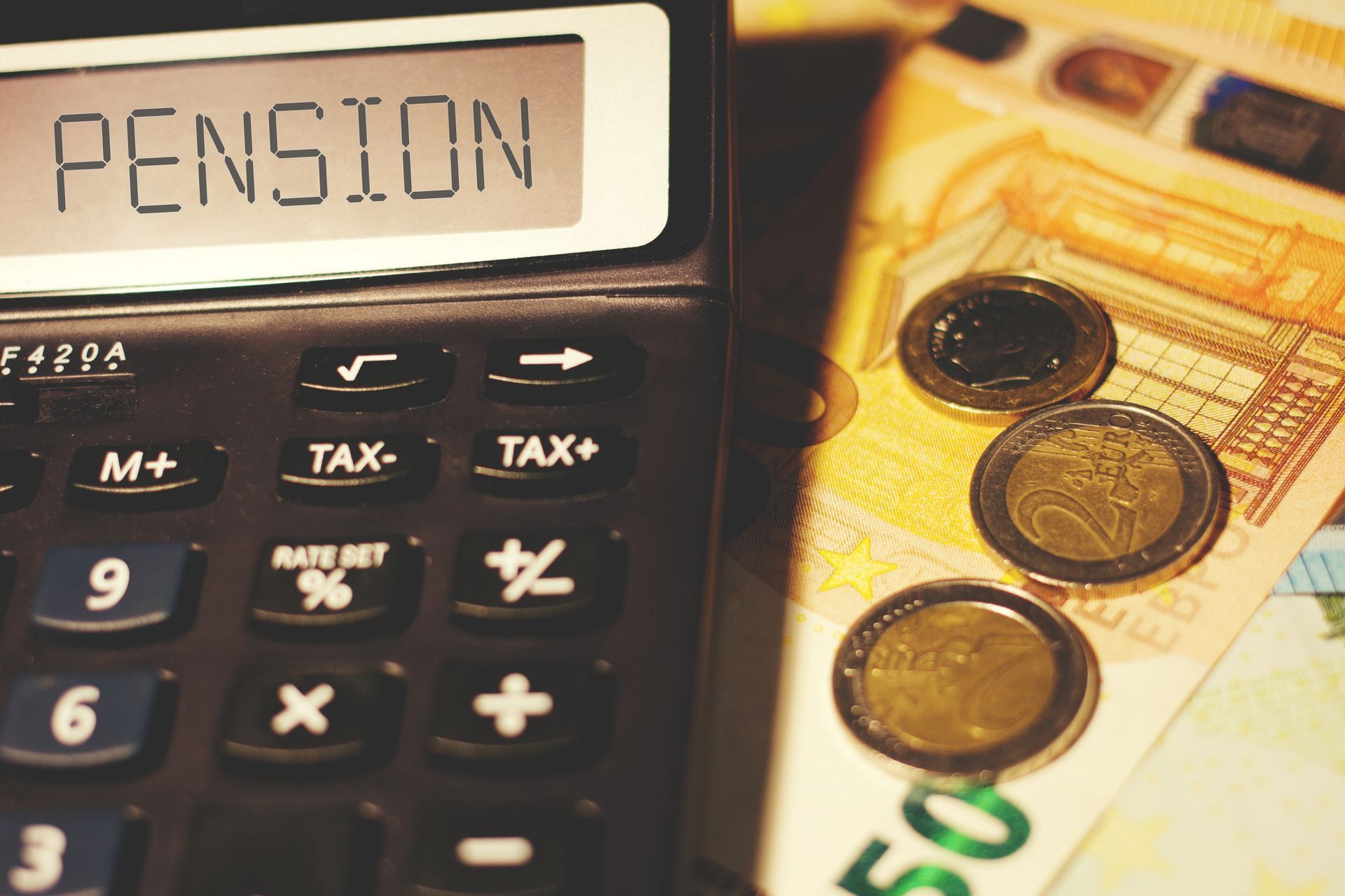 A calculator with the word pension on the screen