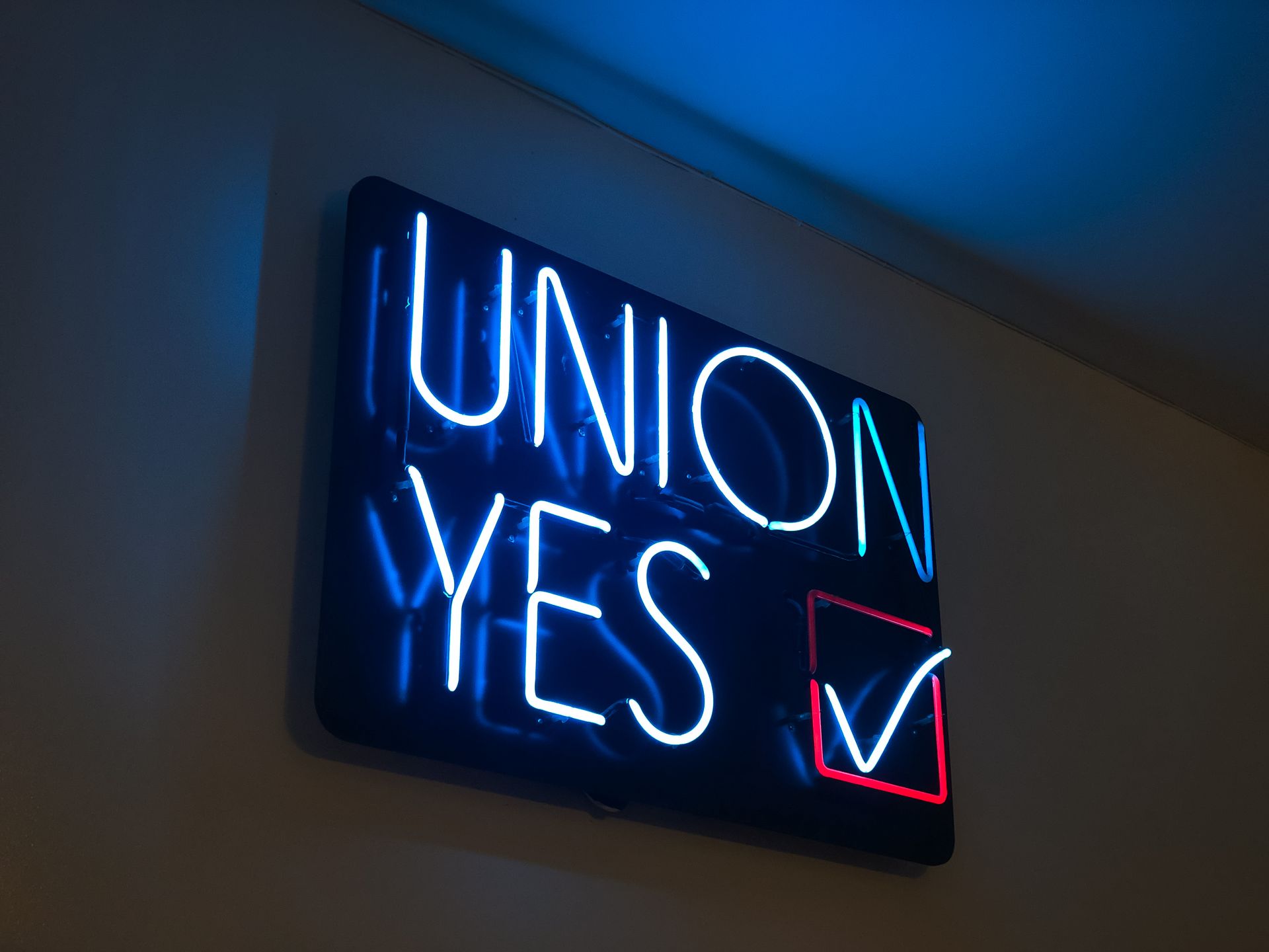 A neon sign that says union yes with a check mark