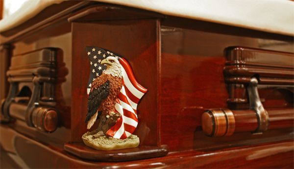 A coffin with an american flag and an eagle on it