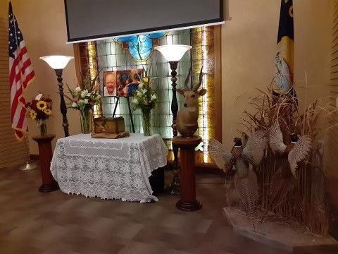 There is a table in the middle of the room with a picture of a man on it.