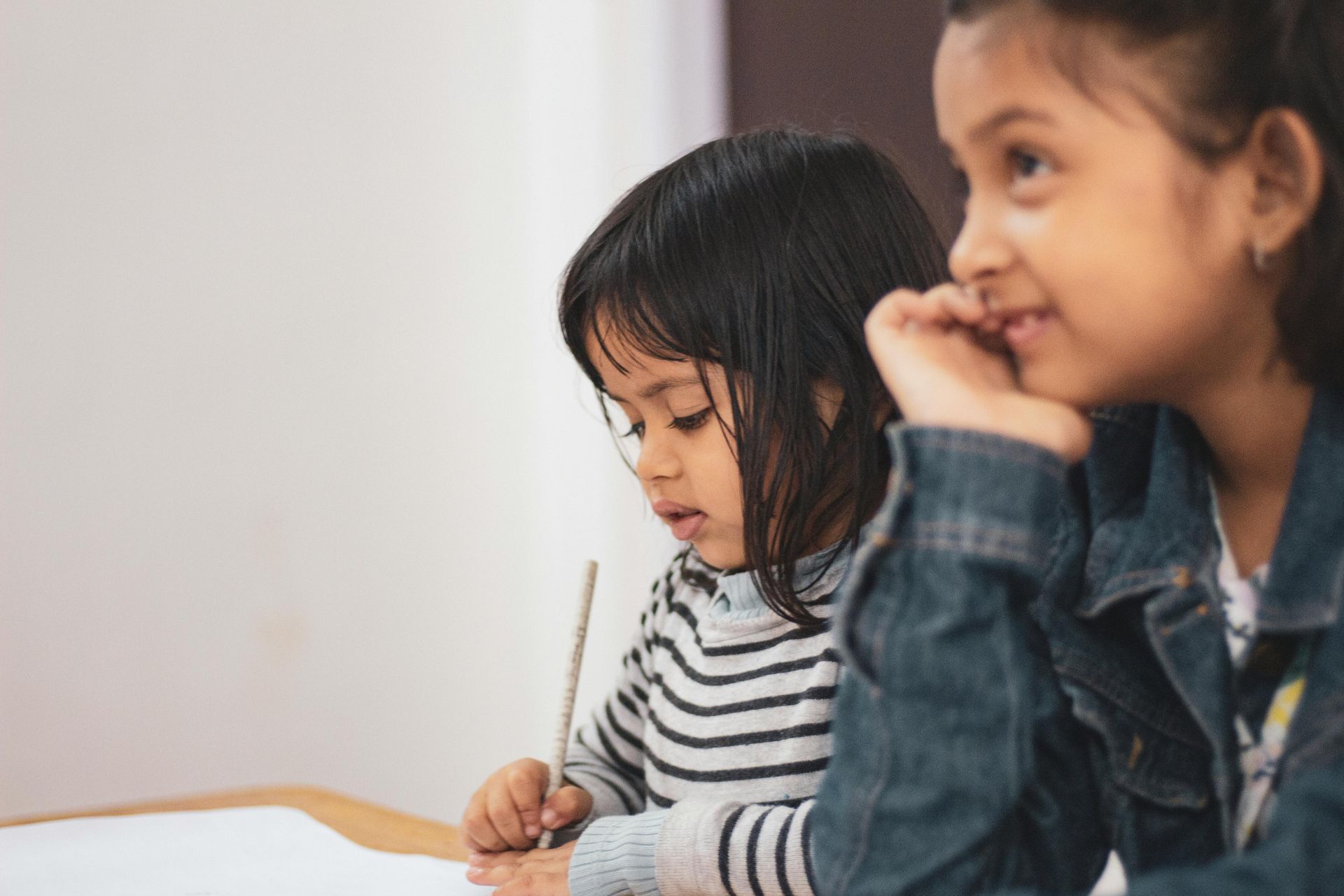 Young children focused during class activity at enrichment centre