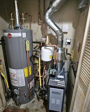 Basement utility room with water heater, furnace, ductwork, and copper pipes.