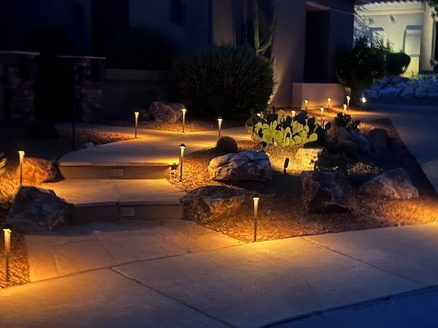 A driveway with a lot of lights on it at night.