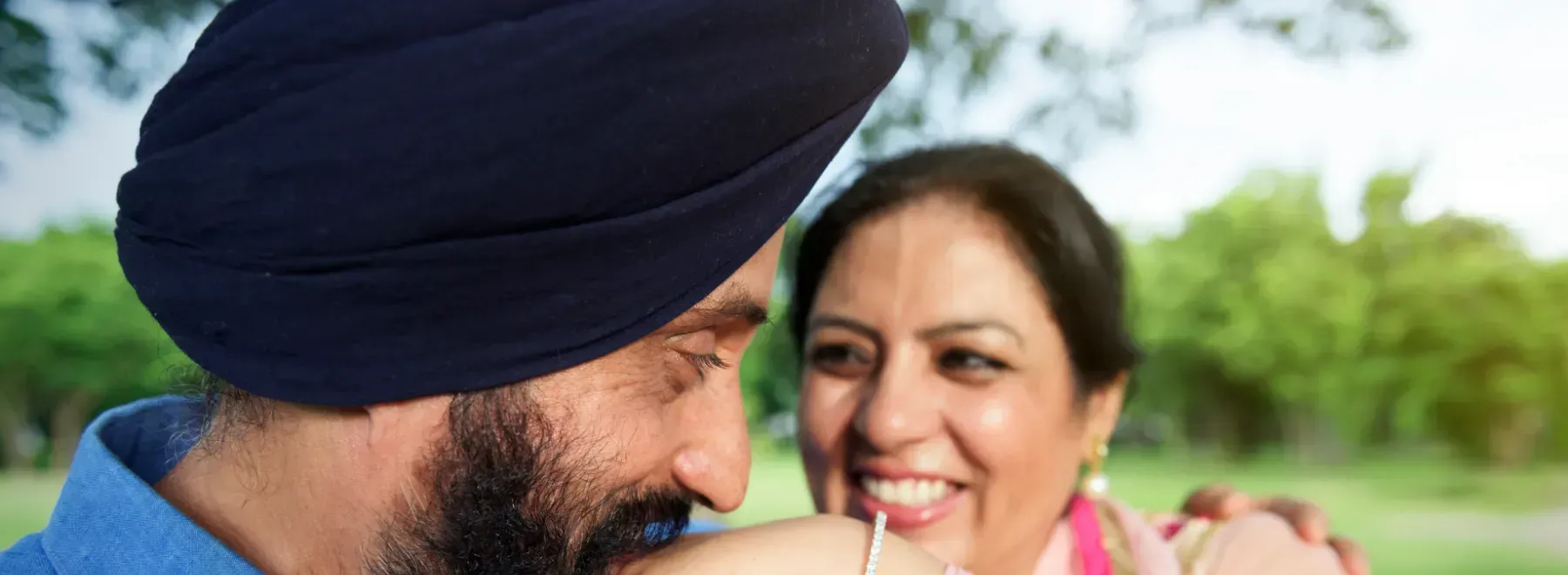Sikh couple smiling together outdoors in a Brampton park
