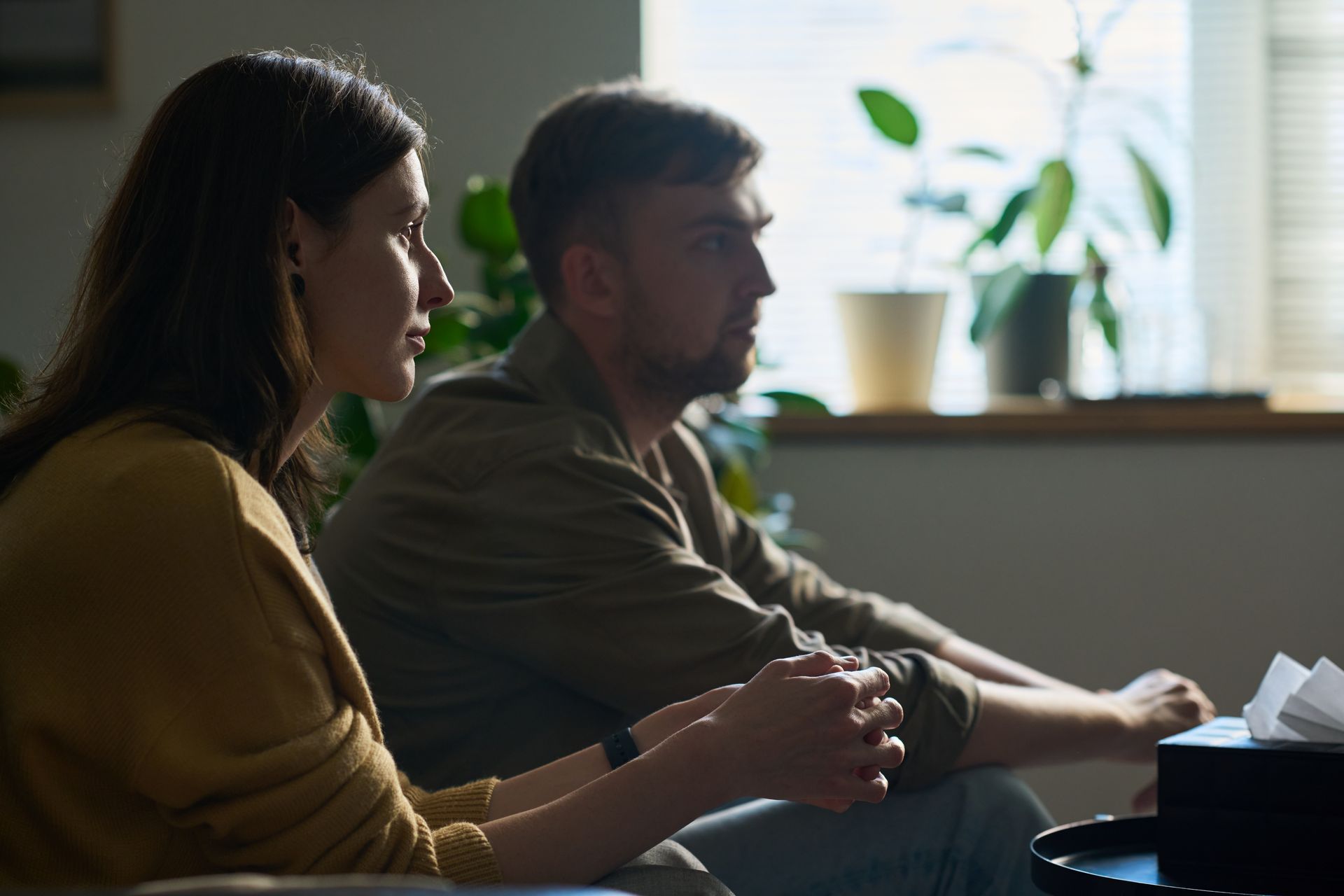 Couple sitting together thoughtfully, considering whether their marriage is worth saving