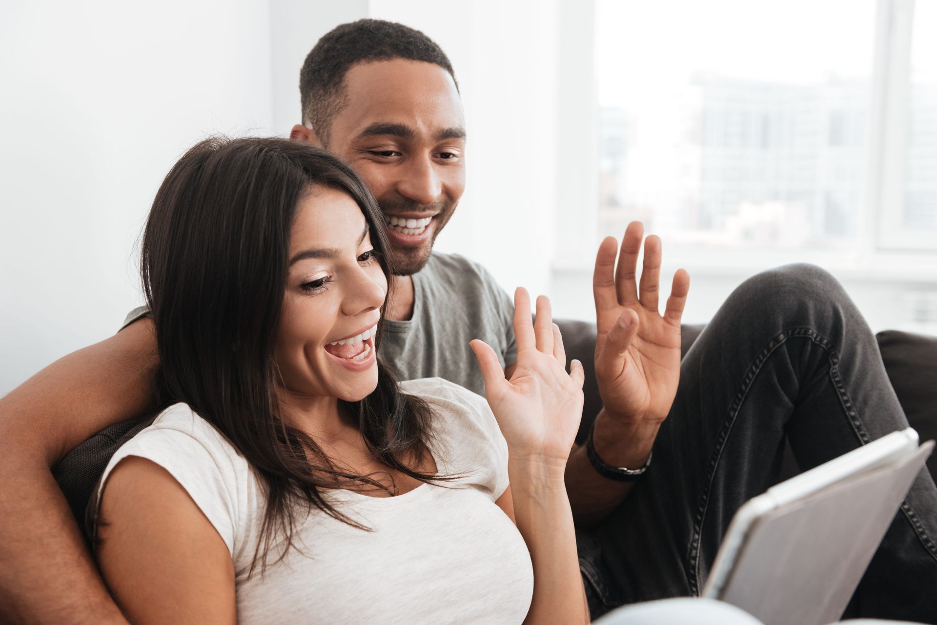 Couple on a video call with their Toronto-area couples therapist during an online session