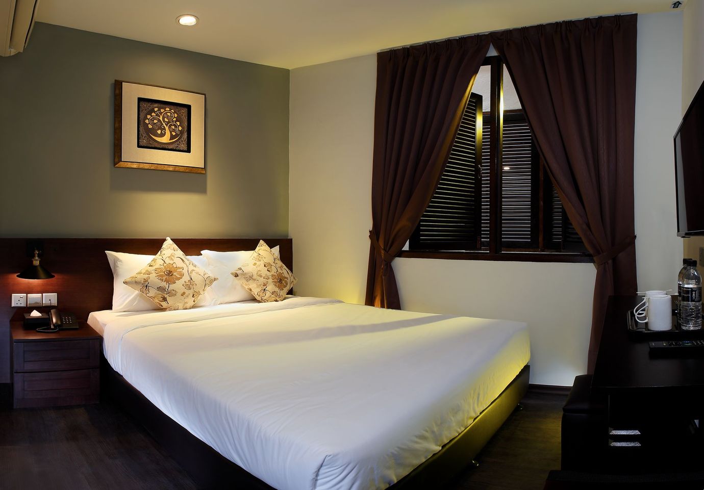 A hotel room with a large bed and a window