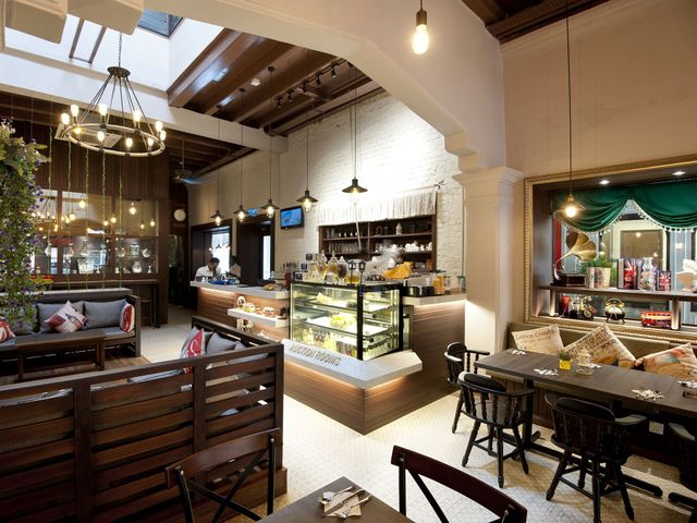 A restaurant with tables and chairs and a display case