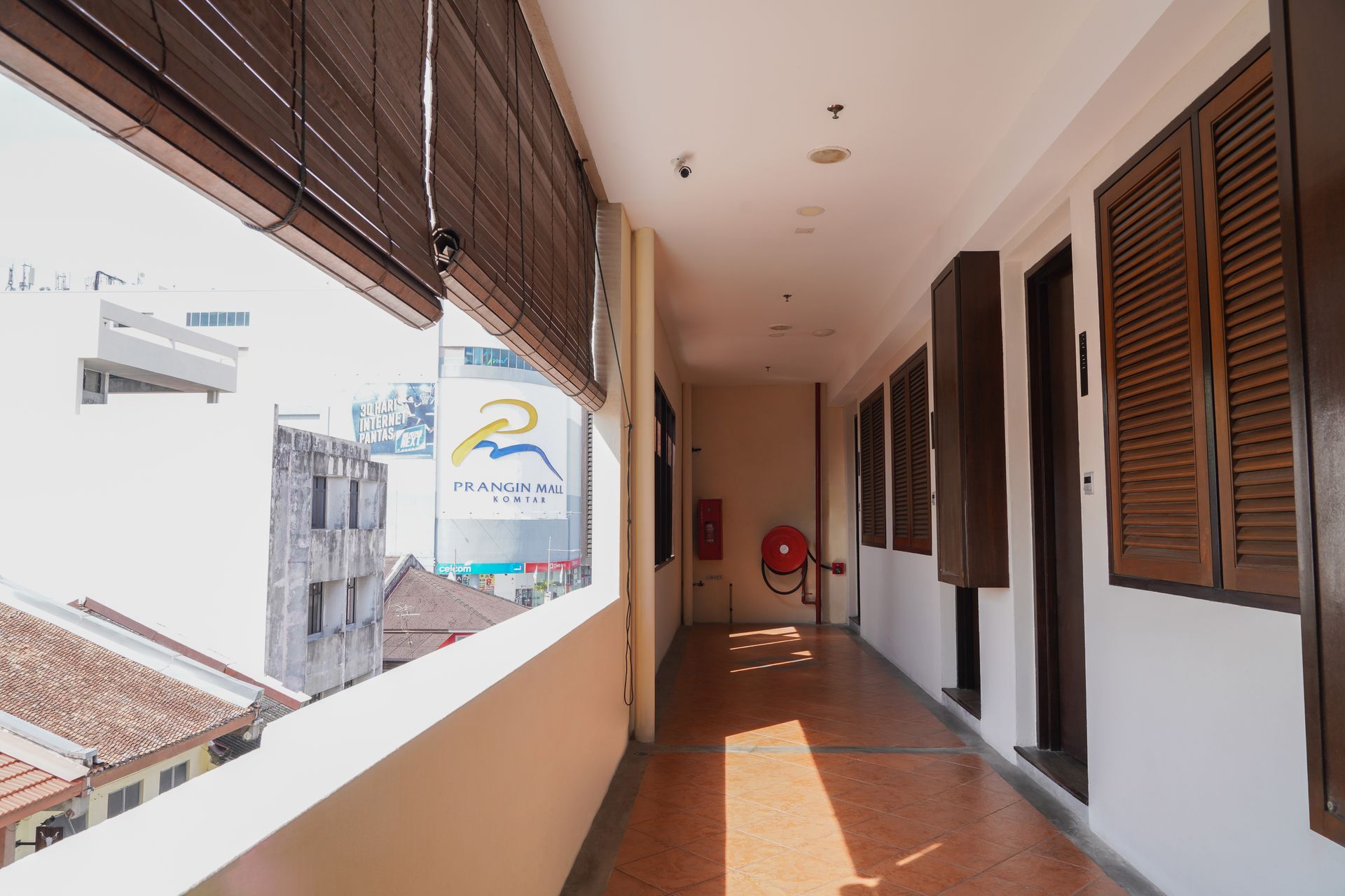 A long hallway with a fire extinguisher in the middle of it