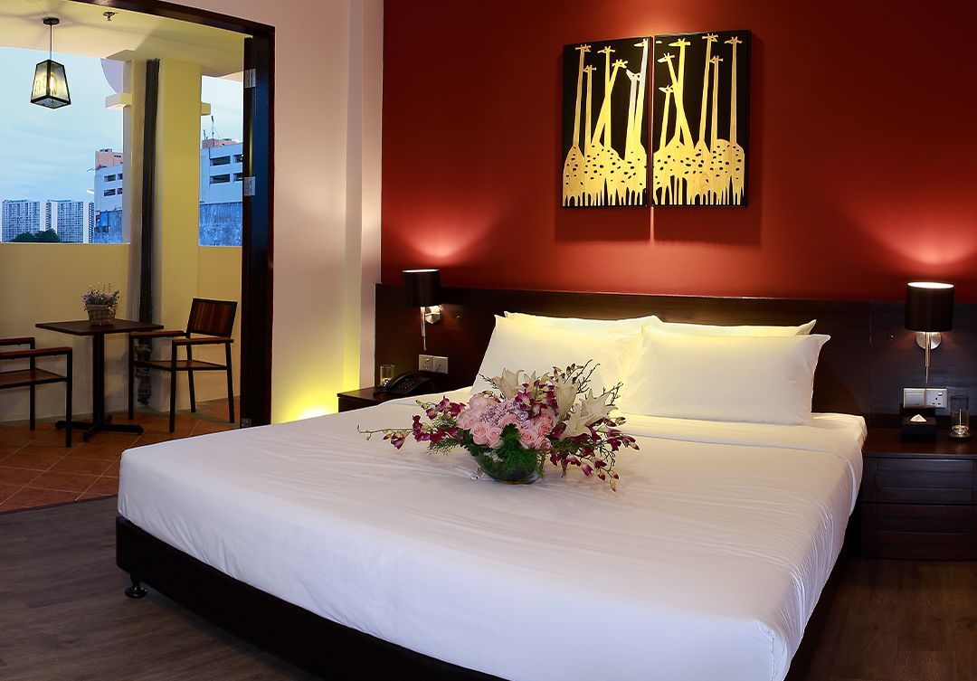 A hotel room with a large bed and a painting on the wall