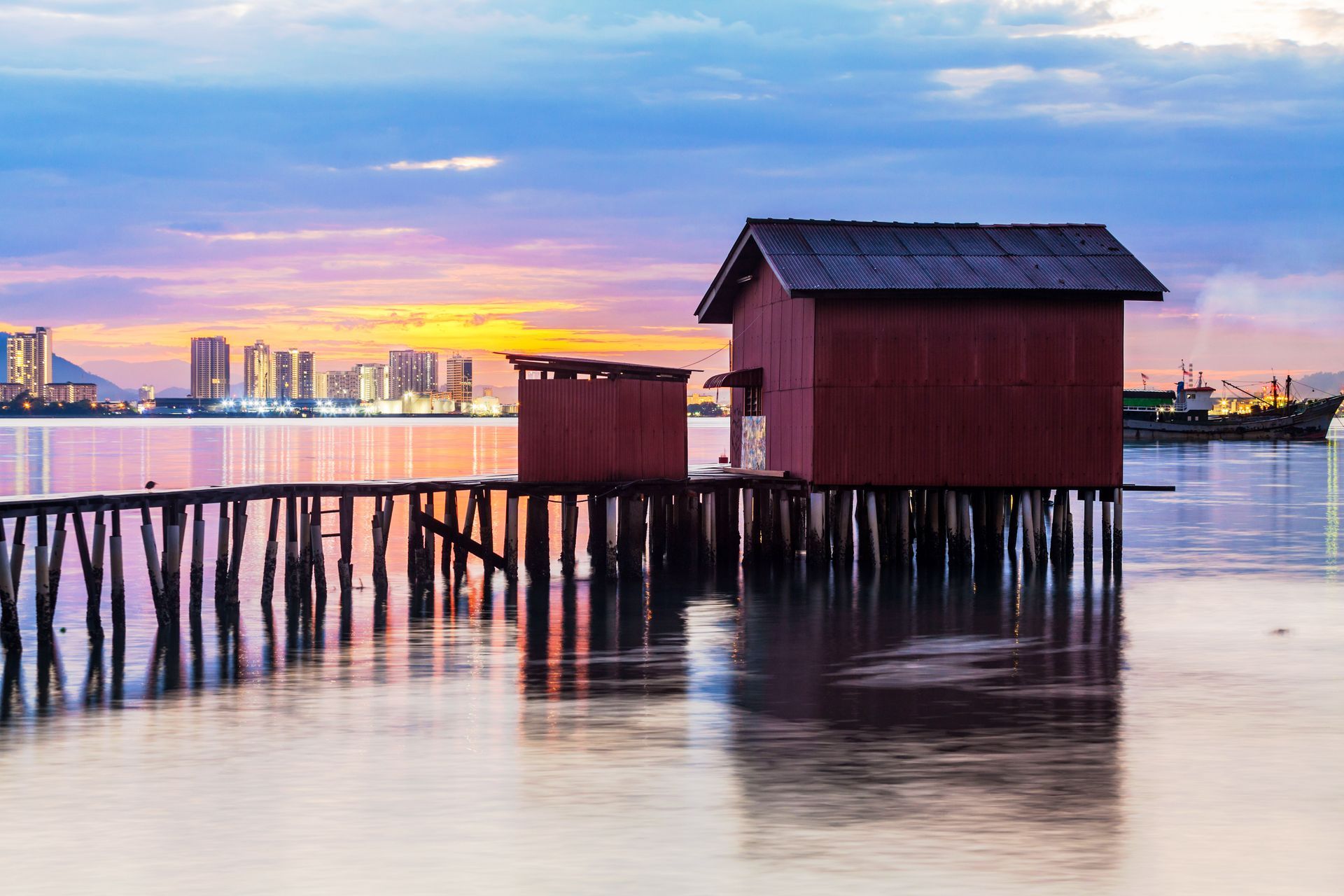 A small house on stilts in the middle of a body of water.