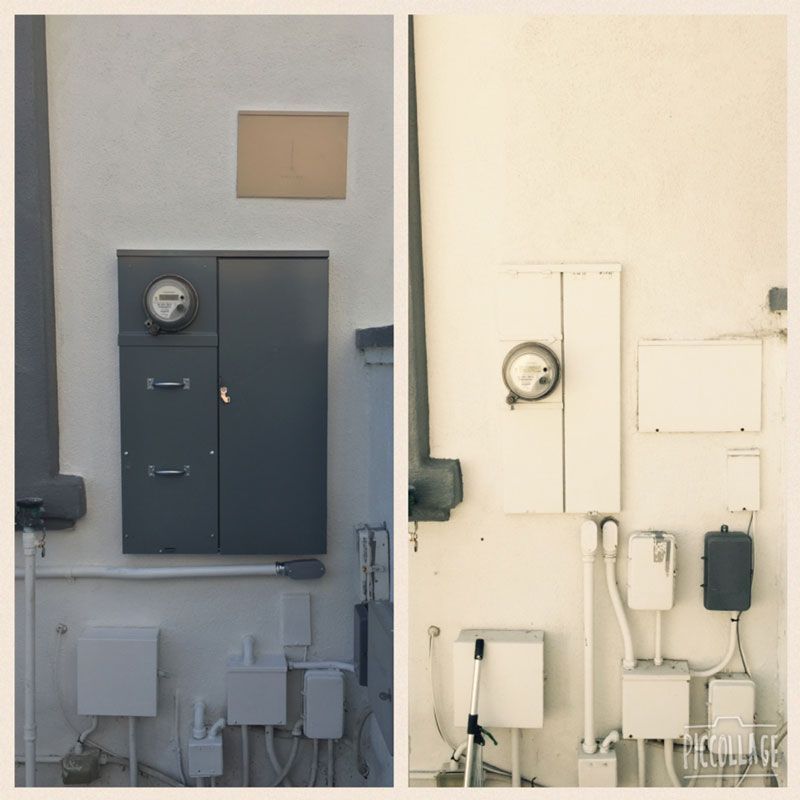 Side-by-side utility meters and electrical boxes on a wall, shown in dark and light tones.