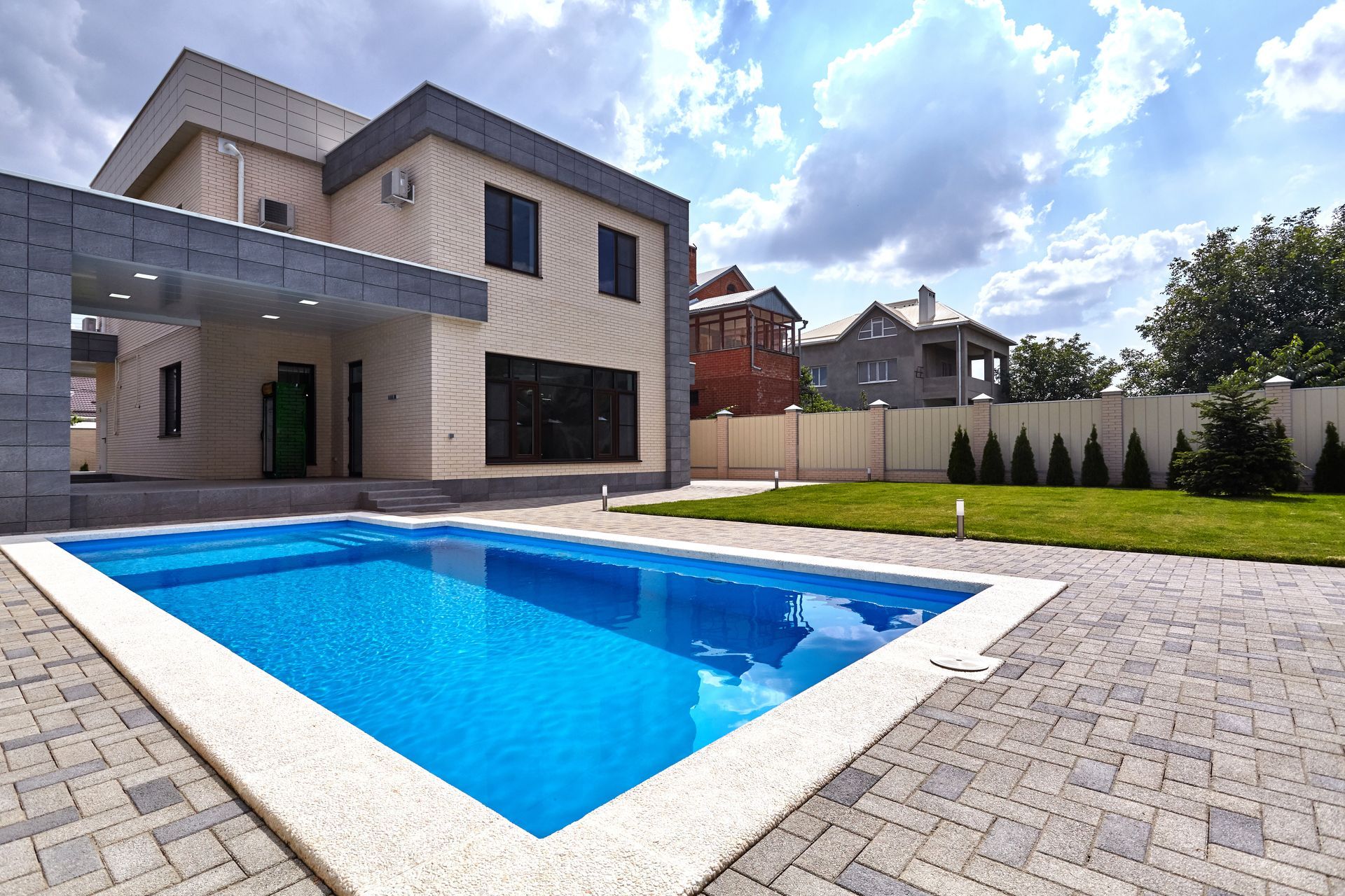 a large house with a swimming pool in front of it