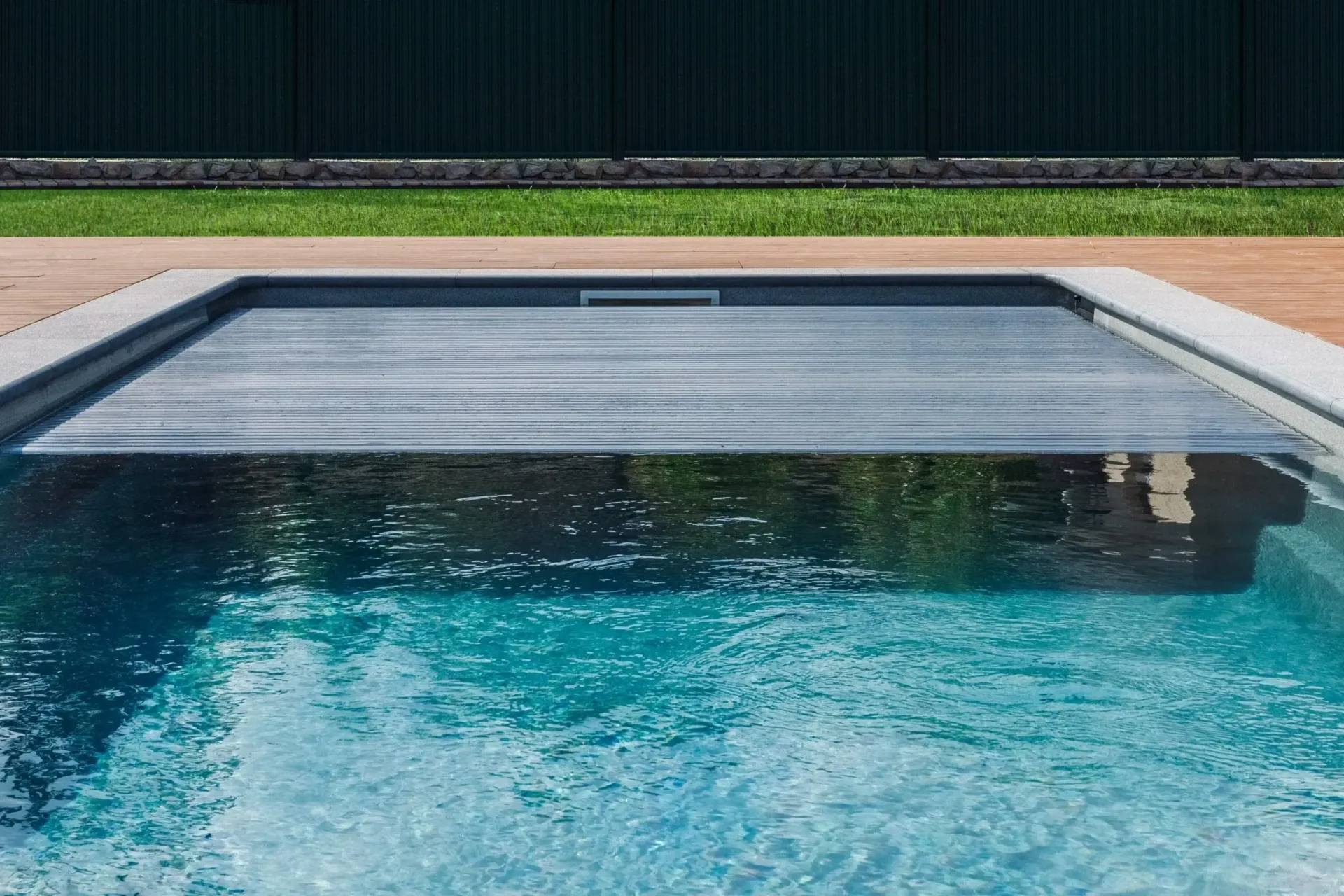 A swimming pool with an automatic pool cover