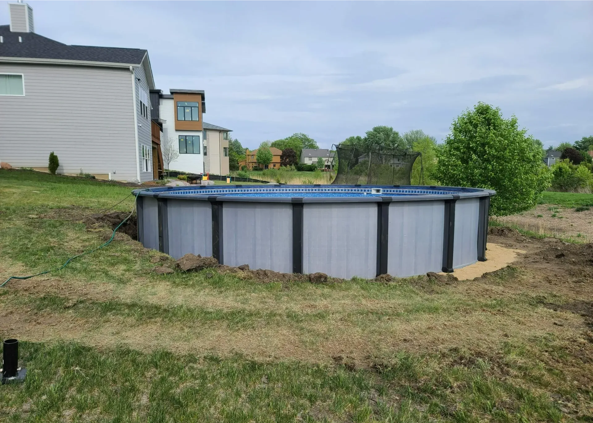 Elegance Inground rectangle fiberglass pool with corner sun shelf.